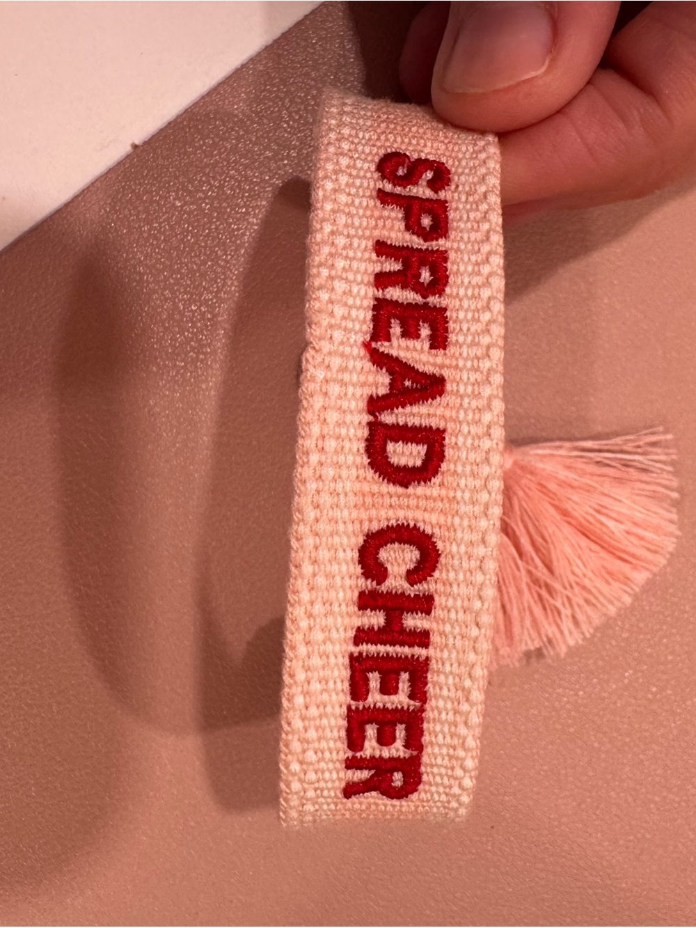 Kenzie Collective Embroidered 'SPREAD CHEER' Woven Bracelet - Pink with Red Text